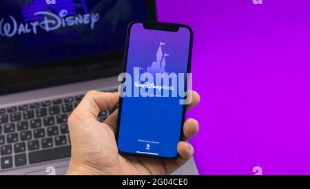 Kharkov, Ukraine - May 28, 2021: Man use My Disney Experience, Walt Disney World app, logo on laptop background Stock Photo