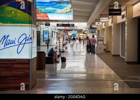 Honolulu, Hawaii.  Daniel K. Inouye International Airport. Travelers walking through the airport concourse. Stock Photo