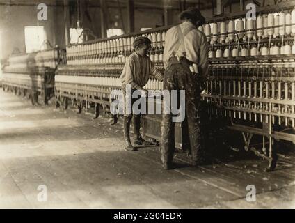 Child Labour: A young boy working as a doffer in a North Carolina cotton mill Stock Photo