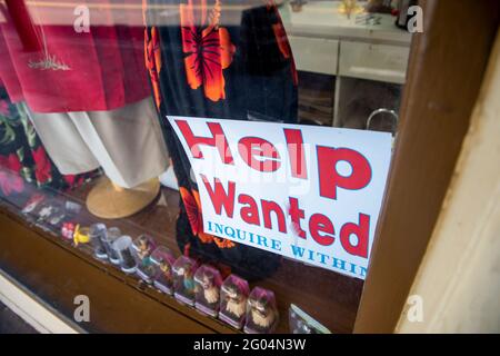 Help wanted sign in window of a local shop in Maui, Hawaii. Stock Photo