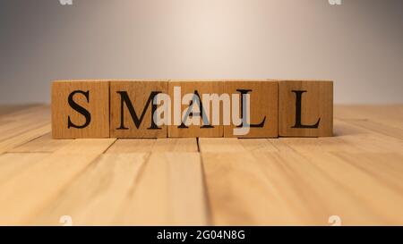 The word small created from wooden cubes. Stock Photo