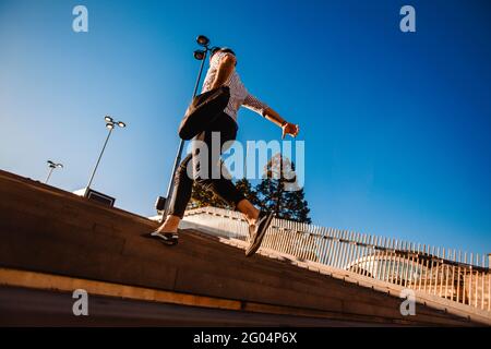 Hurrying to the new goals. Happy young man in formalwear holding briefcase while running Stock Photo