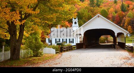 USA; STARK, NEW HAMPSHIRE; FALL AUTUMN COLOR; STARK COVERED BRIDGE OVER THE UPPER AMMONOOSUC RIVER; STARK UNION CHURCH Stock Photo