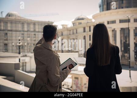 Well suited female boss and handsome businessman are talking about the future plan Stock Photo