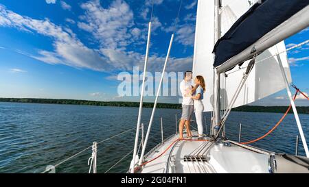 Loving Couple Hugging Standing On Boat Deck Having Date Outdoors Stock Photo
