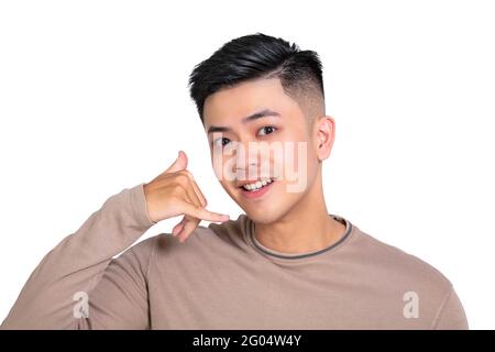 Young man doing phone gesture like says call me back Stock Photo