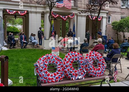 NEW YORK, NY – MAY 31: A participant reads name Names of post members who passed away at the American Legion Boulevard Gardens 2021 Memorial Day Ceremony on May 31, 2021 in the Queens borough of New York City. Memorial Day is a federal holiday honoring military personnel who have died in performance of their military duties. Credit: Ron Adar/Alamy Live News Stock Photo