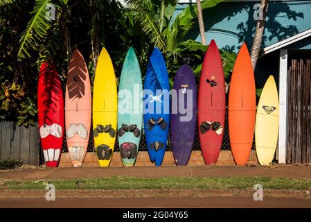Maui, Hawaii.  A variety of different colored surfboards stand out in the beautiful evening light Stock Photo