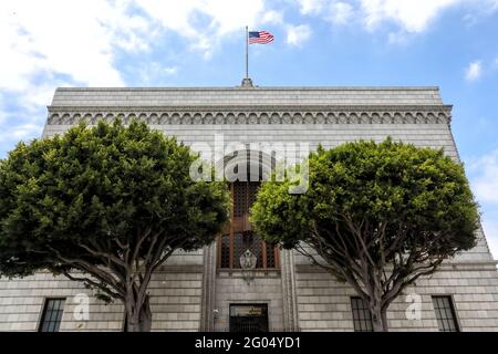 Long Beach, California, USA. 26th May, 2021. The American flag waves on top of the roof of the Scottish Rite Cultural Centre where the First Annual 'Run for the Rite' festival and concert event was held to benefit veterans on Memorial Day weekend  in Long Beach, California.  Built as the Scottish Rite Cathedral in 1926, the Romanesque Revival structure was designated a Historical Landmark (#8) by the City of Long Beach, and is home to the 800-seat Ernest Borgnine Theater.  Credit: Sheri Determan Stock Photo