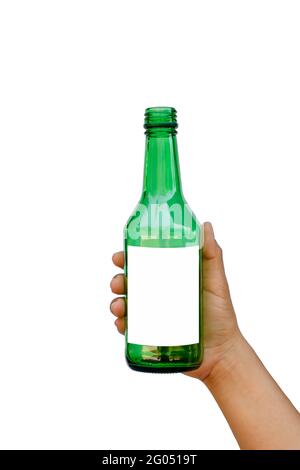 Hand holding an empty green glass bottle with a text space isolated on a white background with the clipping path. Stock Photo