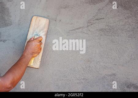 Home improvement ideas. Close-up of workers plastering walls to build a house with empty spaces for text. Stock Photo