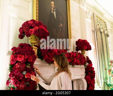 First Lady Melania Trump looks at a rose garland in the State Dining Room of the White House Sunday, Dec. 1, 2019, during a review of the Christmas decorations Stock Photo