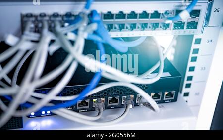 Network switch and ethernet cable in data center. Wifi plug of internet router for computer. Network hub. Communication networking wireless. Network. Stock Photo
