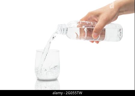 Man's hand pouring water into a glass. Stock Photo