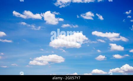Cumulus white clouds floating in blue sky, concept for design to make wallpaper. Stock Photo