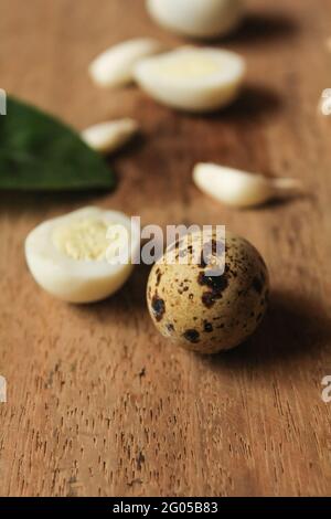 Quail eggs on wooden surface, bowled eggs Stock Photo