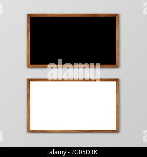 Two Horizontal Frames on grey wall with wooden Borders. 2 Rectangular frame hanging in gray wall . One brown wood Black blank and 1 wooden white blank. Stock Photo