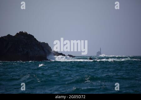 Fastnet lighthouse, as seen from the rocks of Cape Clear Island, Ireland's most southerly inhabited island, off the coast of Co. Cork. The Fastnet roc Stock Photo