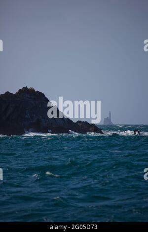 Fastnet lighthouse, as seen from the rocks of Cape Clear Island, Ireland's most southerly inhabited island, off the coast of Co. Cork. The Fastnet roc Stock Photo