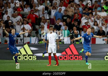 File photo dated 27-06-2016 of Iceland's Kolbeinn Sigthorsson (right) celebrating scoring his side's second goal as England's Raheem Sterling stands dejected during the Round of 16 match at Stade de Nice, France. Issue date: Tuesday June 1, 2021. Stock Photo