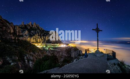 Creu de Sant Miquel Vewpoint, in Montserrat, at night, with a night sea of clouds - fog (Barcelona, Catalonia, Spain) Stock Photo