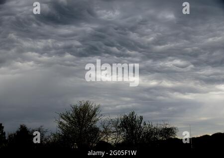 Storm clouds form an eye in the sky. Stock Photo