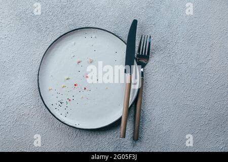 Empty plate with crumbs after eating. The concept of the end of celebration. Top view, flat lay Stock Photo