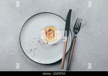 Empty plate with crumbs after eating on table. The concept of the end of celebration. Top view Stock Photo