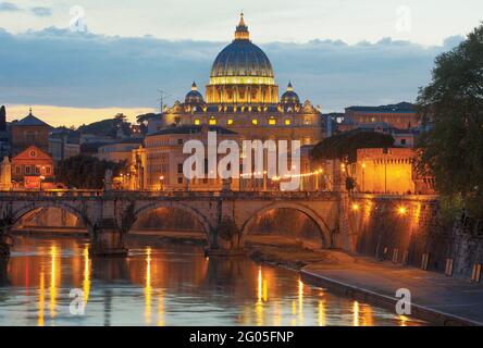 Rome, Italy.  Sant'Angelo bridge and St Peter's Basilica at dusk.  The historic centre of Rome is a UNESCO World Heritage Site. Stock Photo