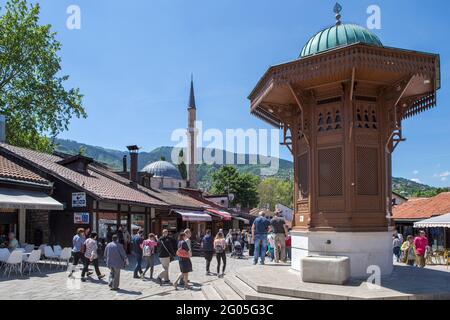 Water fountain plus Bascarsijska mosque, Bascarsija, old town, Sarajevo, Bosnia and Herzegovina. Sebilj is a Ottoman-style wooden fountain (sebil) in Stock Photo