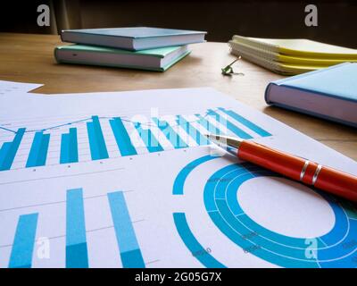 Business statistics and data analysis. Papers with financial results on the table. Stock Photo