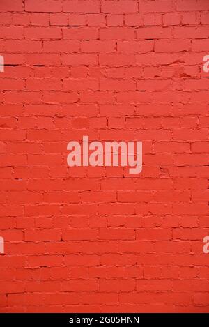 A new paint job on an old brick wall creates a colourful  textured background Stock Photo