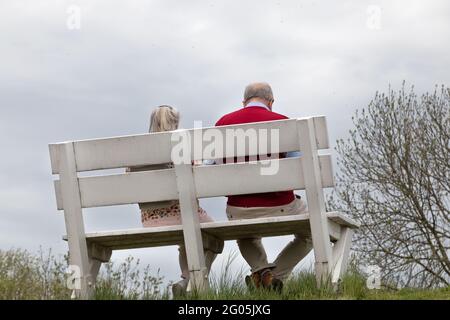 elderly couple on a park bench Stock Photo