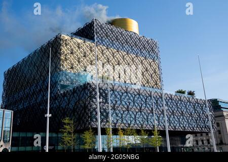 Smoke is released from Birmingham Library to represent nitrogen oxides saved by the clean air zone launched today in Birmingham. The Birmingham Clean Air Zone (CAZ) charges highly-polluting vehicles, including cars, for entering the heart of Birmingham. Under the scheme non-compliant cars, taxis and vans will have to pay an £8 daily charge – with enforcement cameras operating around the clock every day of the year. Picture date: Tuesday June 1, 2021. Stock Photo