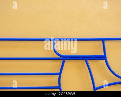 Angular blue metal gate against a plain wall, MK Gallery, Milton Keynes, UK Stock Photo