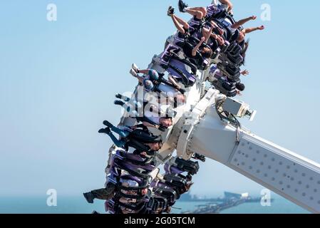 Thrill riders on Axis ride on seafront theme park of Southend on Sea, Essex, UK, as England opens up after lockdown on May Bank Holiday Monday 2021 Stock Photo
