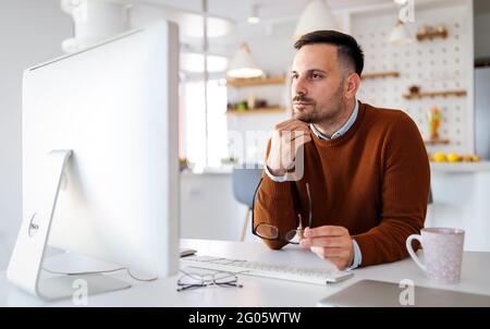 Confident businessman team leader lead group videoconference meeting. Home office concept Stock Photo