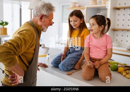Grandfather is scolding his grandchildrens girls. Family, punishment, discipline concept Stock Photo