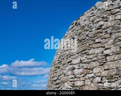 The dry stone wall structure of the Broch of Clickimin in Lerwick, Shetland, UK - taken on a sunny day with blue sky and white clouds Stock Photo