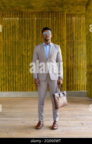 Portrait of handsome young African businessman wearing suit Stock Photo