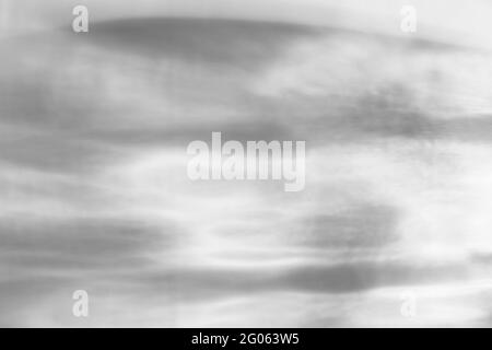 Glass drops diagonal shadow and light caustic effect on a white wall. Caustics formed by the refraction of the sun in a bottle on a light table. rays, Stock Photo