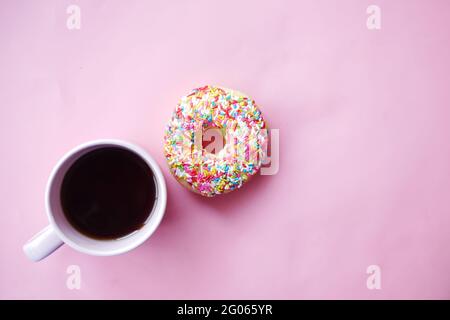 top view of colorful tasty donuts and coffee cup on pink  Stock Photo