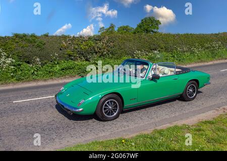 1973 70s green Lotus Elan +2s 130-5 driving on country roads en-route to Capesthorne Hall, classic car show in Cheshire, UK Stock Photo
