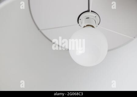 Energy saving light bulb ball in ceiling lamp at home. Power energy saving with LED lamp Stock Photo