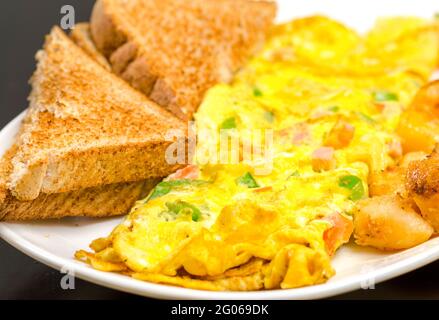 Omelette and toasts. Food with a dark background Stock Photo