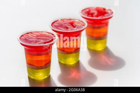 Colorful rainbow jelly on white background, fruit jelly dessert for party. Close up. Stock Photo