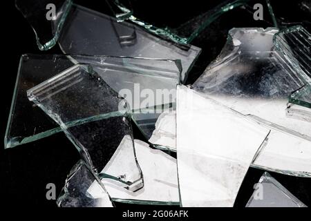 https://l450v.alamy.com/450v/2g06afk/pieces-of-broken-glass-on-a-black-background-high-quality-photo-2g06afk.jpg