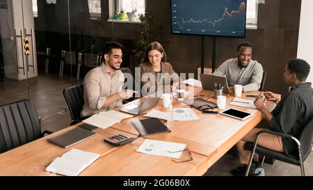 Colleagues having meeting in boardroom, working on startup Stock Photo