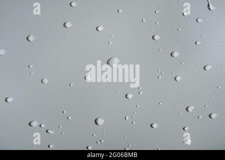 Water drops on gray background, top view. Copy space. Stock Photo