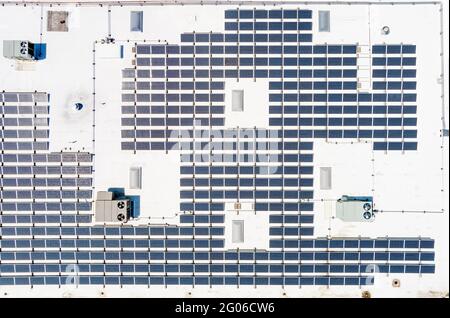 Aerial view of solar panels on roof of commercial building Stock Photo